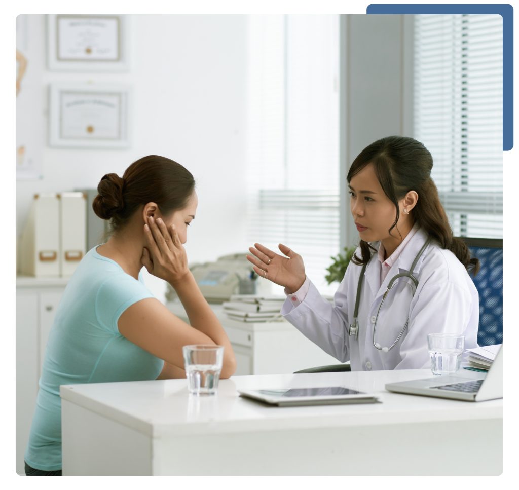 A woman engages in a conversation with a doctor in a medical office, seeking advice on her health issues.