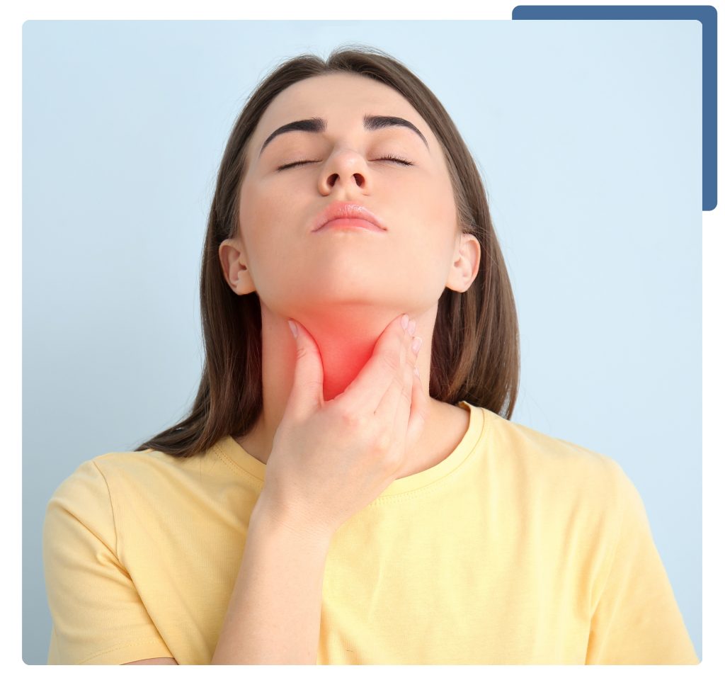 A woman holding her throat, indicating discomfort or pain, with a concerned expression on her face.